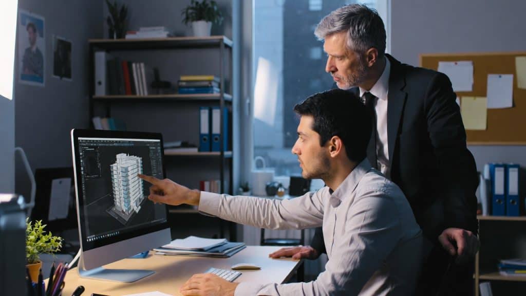 Deux architectes analysant maquette 3D sur ordinateur