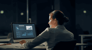 Femme analysant des graphiques sur ordinateur au bureau